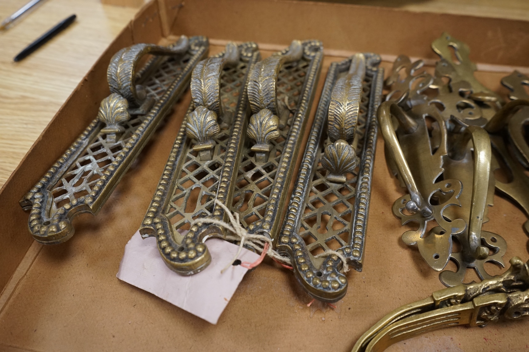 A collection of 19th century cast brass tie backs, largest 26cm high